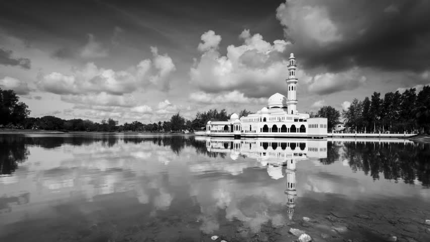Time lapse footage of a beautiful floating public mosque in fine art black and white with amazing mirror reflection on a lagoon in Terengganu, Malaysia known as Masjid Terapung Kuala Ibai. 4K format.