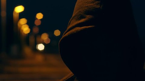 faceless hooded man in the city night. Fear,danger,mistery-slow motion