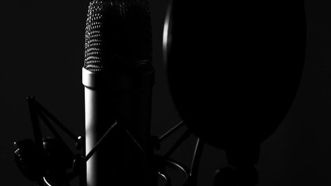 Large diaphragm condenser microphone in a music studio, lit with rembrandt lighting ing shot)