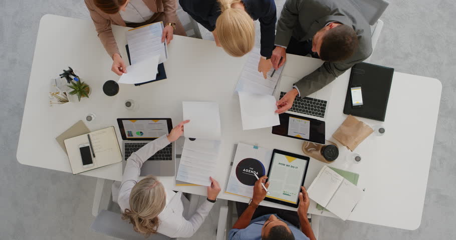 professional multi ethnic business team sharing ideas in boardroom meeting brainstorming corporate strategy using market statistics in documents top view Royalty-Free Stock Footage #1019014930
