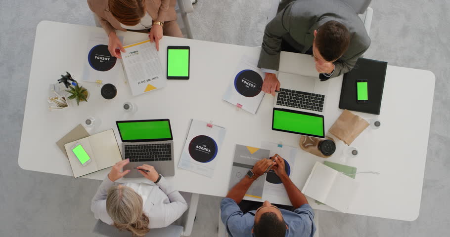 Multi ethnic business team brainstorming innovative ideas for startup company viewing chroma key using mobile computer technology in boardroom meeting above view | Shutterstock HD Video #1019015002