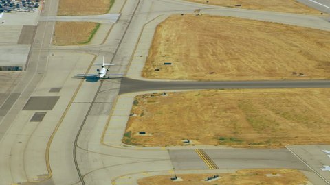 Aerial view of airplanes at Van Nuys airport takeoff launch pad on a sunny day in Los Angeles, California. Shot on 4K RED camera.