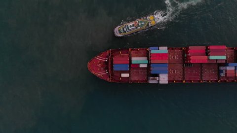 Aerial view of cargo ship carrying container sailing to open ocean concept freight shipping ship
