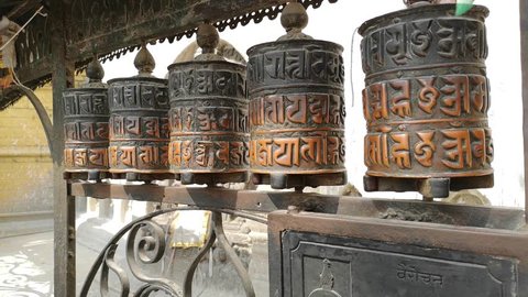 Prayer Drums In Swayambhunath or monkey temle. Kathmandu, Nepal. Swayambhunath, or Swayambu or Swoyambhu, is an ancient religious architecture atop a hill in the Kathmandu Valley.