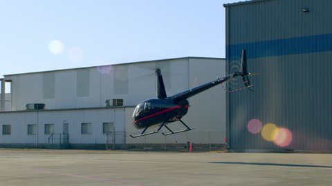 Aerial view of helicopter taking off at airport during the day in Los Angeles, California. Shot on 4K RED camera.
