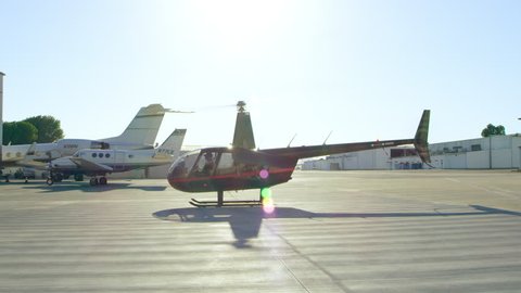 View of helicopter hovering at airport during daytime in Los Angeles, California. Shot on 4K RED camera.: film stockowy