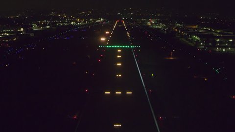 Aerial POV view landing on a runway on a clear night in Los Angeles, California. Shot on 4K RED camera.