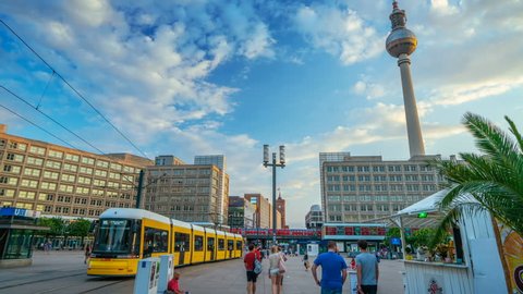 Berlin, Germany- Circa 2018: Hyper lapsed view of the crowded Alexanderplatz in Berlin. Trams arriving and departing, people walking. Famous TV antenna and the World Clock in the background.