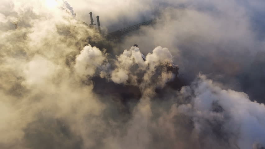Aerial view over industrialized city. pollution from metallurgical plant. Dirty smoke and smog from pipes of steel factory and blast furnaces. Ecological | Shutterstock HD Video #1019031382