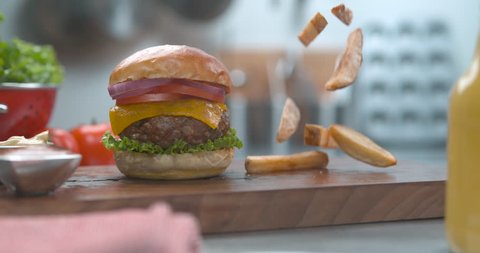 Hamburger heaven. The last food shot you will ever need. Mouthwatering crispy french fries falling super slow motion. Shot on phantom flex, 4k 1000fps. Get this shot before someone else gobbles it up.