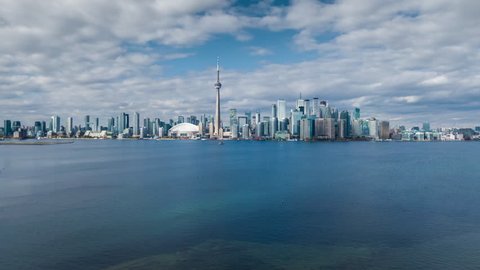 Aerial motion time lapse sequence showing iconic Toronto skyline and Lake Ontario in Toronto, Ontario, Canada. 