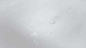 Footage of creamy milk swirling whirlpool background for food dairy product