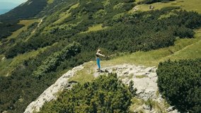 Aerial View Running woman. Runner is jogging in summer sunny day around trees and mountains background under sun light with blue sky, Drone 4K Video Aerial View
