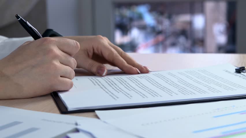 Business woman with french manicure signs a agreement. Woman signs a document. Signing of the lease contract - fake signature | Shutterstock HD Video #1019057533