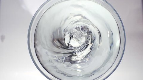 Fruit powder falling to water swirl in glass,  Slow motion