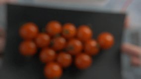 Red cherry tomatoes fly beautifully in slow motion