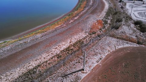 EIn Harod lake, Israel - drone - Aerial movement along the lake, fields, hill, road with cars, plants-In summer 2018