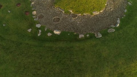 Cairnpapple Hill, near Torphicen in West Lothian, Scotland. A Neolithic ceremonial henge monument. Aerial footage tilt to reveal its place in the landscape. 