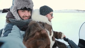 Selfie video of two tourists in snowmobile have a ride in tundra in the middle of Arctic.