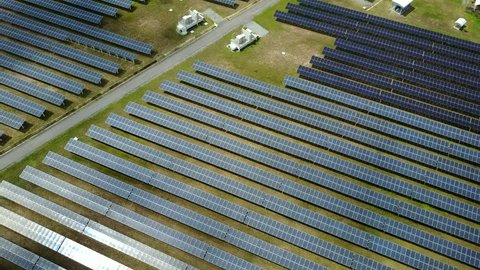 4K. Aerial view of Solar panel farm or solar power plant. Alternative renewable energy with photovoltaic cell industry. Green energy technology for future concept
