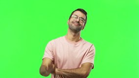 Man on green screen chroma key background saluting with hand with happy expression