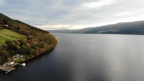 Aerial flyover shot of northeast end of Loch Ness and hillside in early morning