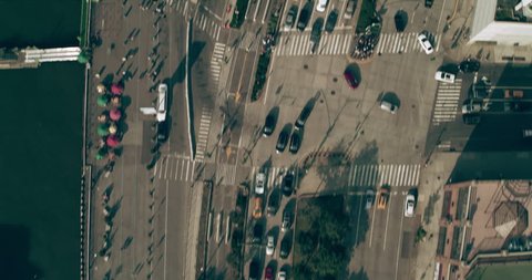 Aerial top down view of Manhattan cars driving near boardwalk in New York during the day under overcast blue sky. Wide shot on 4K RED camera.