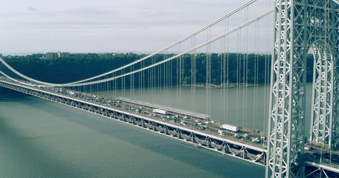Aerial view of Manhattan George Washington Bridge in New York during the day under overcast blue sky. Wide shot on 4K RED camera.
