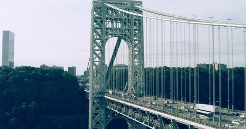 Aerial view of Manhattan George Washington Bridge in New York during the day under overcast blue sky. Wide shot on 4K RED camera.