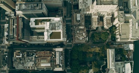 Aerial top down view of Manhattan skyine skyscrapers in New York during a summer day under blue skies. Wide shot on 4K RED camera.