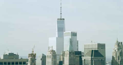 Aerial view of Manhattan skyline skyscrapers in New York during the day under blue skies. Wide shot on 4K RED camera.