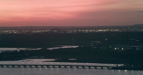 Aerial view of Manhattan island city skyline in New York during pink sunset. Wide to Long shot on 4K RED camera.