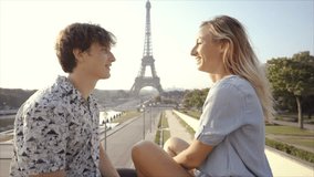 Young couple having fun in Paris city near the Eiffel Tower enjoying summer in the capital city, Europe travel