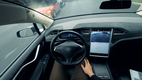 Person controls a self-driving car. Autonomous autopilot driverless car