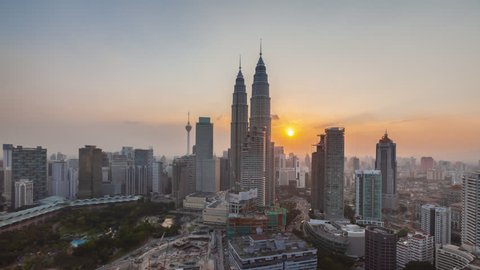 KUALA LUMPUR, MALAYSIA - March 2016: Time lapse of beautiful and dramatic sunset view of a cityscape in Kuala Lumpur, Malaysia. Prores Full HD. 4K Available. Pan down motion timelapse