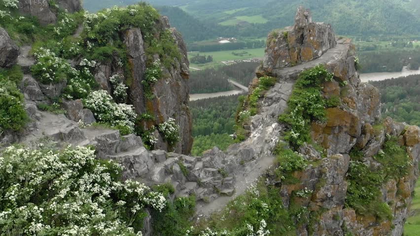 Mountain peak, summer landscape, beautiful span between two rocks