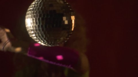 Retro 80s party with a disco ball and a dancing lady on the background