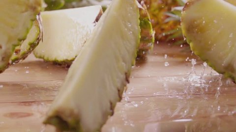 Pineapple divide into slices . Slow motion
