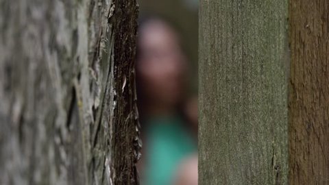 frightened terrified woman hiding by her tormentor in the woods-change of focus