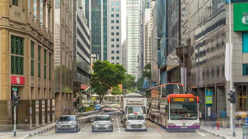 Singapore traffic around the city centre timelapse. Traffic signs, lights and trees around the street. Skyscrapers on background Royalty-Free Stock Footage #1019115568
