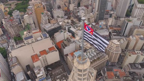 SAO PAULO, BRAZIL - MAY 3, 2018: Aerial View of the city centre Banespa building with city flag. Landmark touristic place. Drone shot in 4K