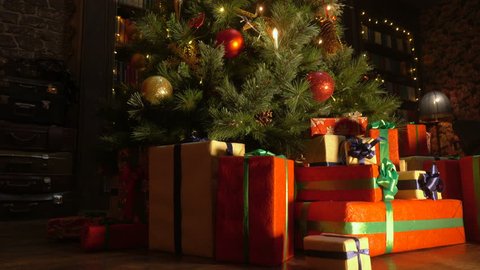 New Year 2019 mood, Christmas tree, happy holidays. Christmas gift box, Christmas ball on glow bokeh lights background.  Christmas interior
