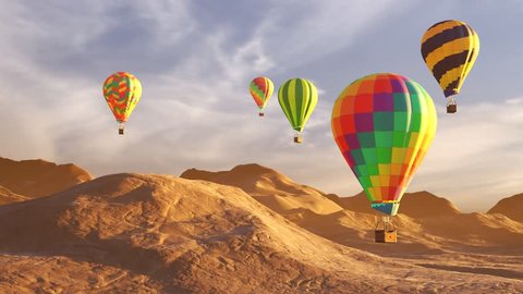 Colorful hot air balloons flying over mountains and desert landscape during sunset. Five large multi-colored balloons slowly rising against a beautiful cloudy sky. Travel, adventure, festival.
