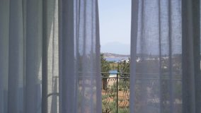 Beautiful view from the terrace to the Bay through the curtains. Wind blowing curtain movements. 4K