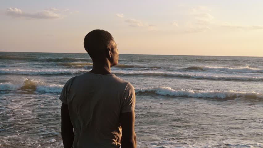 Missing Africa.sad Lonely young african man observing the sunset on the sea Royalty-Free Stock Footage #1019142637