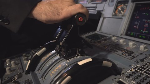 The cockpit of the aircraft. The pilot checks the aircraft engines before takeoff. Preparation of passenger airliner for takeoff. The pilot adjusts the autopilot. 4k