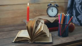 old books, apple, candle, pencils and alarm clock on wooden background. back to school concept - Powered by Shutterstock - Get 15% off with code: PIKWIZARD15