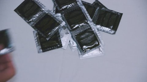 Condoms in black packaging. Male contraceptives. Intimate life. Safe sex life. Prevention of viral diseases