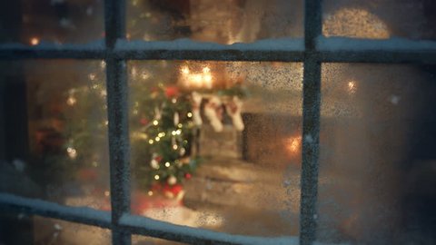 Christmas tree scene through frozen window. Traditional scene with presents under the tree and fire in fireplace. Decorated living room and candle light and socks with presents on fireplace sims.