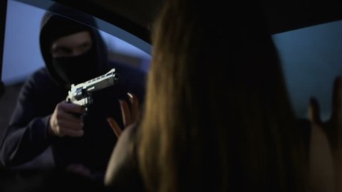 Carjacker threatening female victim with pistol, robber stealing automobile